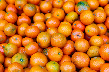 Fresh ripe mandarins on the counter in supermarket, puts out for sale. Close-up image