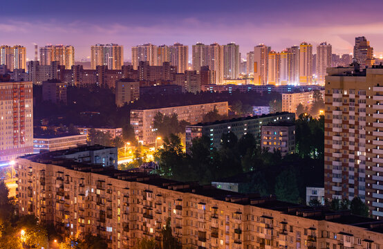 Night colorful windows lights of the high-rise residential building in city sleeping area.