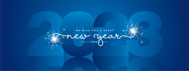 We wish you Happy New Year 2023, modern design, white new updated handwritten lettering with blue 2023 year mirrored shadow in background and sparkler firework