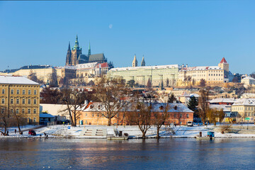 Snowy Prague Lesser Town with Prague Castle above River Vltava in the sunny Day , Czech republic