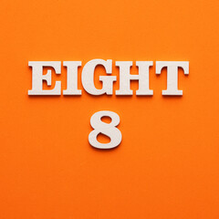 Eight phrase in white letters on orange foamy background