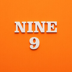 Nine phrase in white letters on orange foamy background