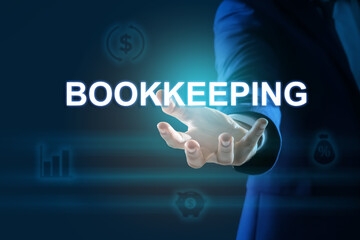 Fototapeta na wymiar Bookkeeping concept. Businessman holding word on dark blue background with digital icons, closeup