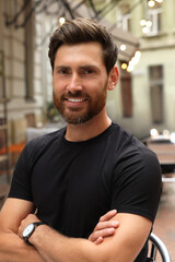 Fototapeta premium Portrait of handsome bearded man in outdoor cafe