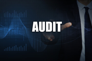 Audit concept. Businessman pointing at word on dark background, closeup. Binary code, graphs and...