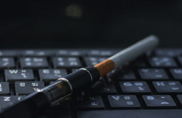 Cigarette filters and cigarettes are on the keyboard.