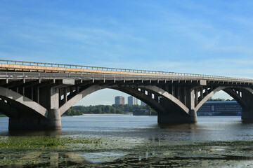 Naklejka na ściany i meble Beautiful view of arch bridge over river on sunny day