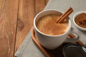 Fotobehang Delicious eggnog with anise and cinnamon on wooden table, closeup. Space for text © New Africa