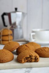 Tasty oatmeal cookies on white marble table, closeup