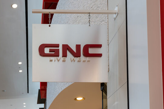 Houston, Texas, USA - March 6, 2022: A GNC hanging sign is shown at a shopping mall. GNC Holdings is a retail company specializing in health and nutrition related products. 