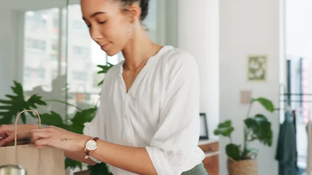Black woman. shopping bag and packing clothes in office for online order, ecommerce delivery or online shopping customer. African woman, fashion designer and prepare retail cargo package for shipping