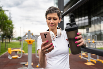 mature caucasian senior woman take a brake during outdoor training