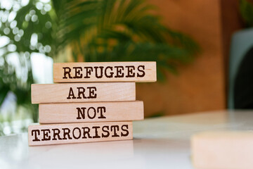 Wooden blocks with words 'Refugees Are Not Terrorists'.