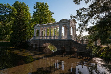 Marble bridge on the shore of a Large pond in the Catherine Park in Tsarskoye Selo on a sunny...
