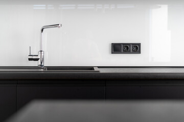 modern water tap at kitchen with dark furniture
