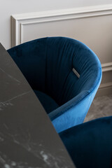 Fototapeta na wymiar blue comfortable armchair near table at contemporary kitchen