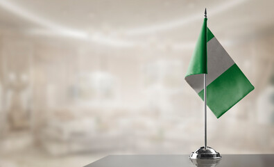 A small Nigeria flag on an abstract blurry background