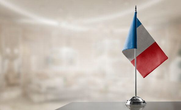 A small France flag on an abstract blurry background
