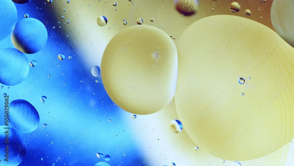Aufkleber real close up oil bubbles in water rotation with color gradient abstract mixing background.