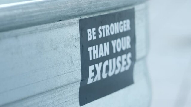 Be Stronger Than Your Excuses Sticker On An Ice Bath Basin. closeup