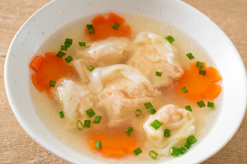 shrimp dumpling soup in white bowl