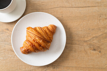 fresh croissant on white plate