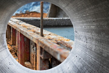 Reinforced concrete foundation of a modern monolithic residential building. Prepared formwork with reinforcing mesh for pouring concrete. Monolithic construction technologies.