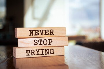 Wooden blocks with words 'Never Stop Trying'.