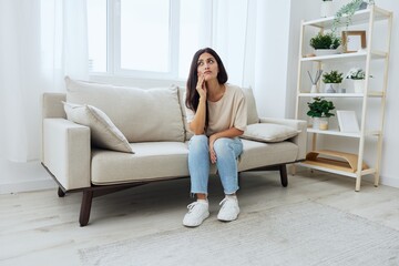 Fototapeta na wymiar Woman toothache, tooth root inflammation sitting on sofa at home