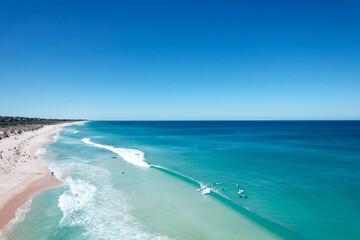 Aerial view of surfers catching a wave at Scarborough Beach in Perth, Western Australia