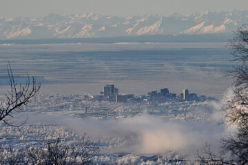 Anchorage, Alaska, city landscape with fog, ice and snow.