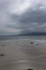 beach and sea with mountains in the back
