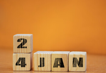 Cube shape calendar for January 24 on wooden surface with empty space for text, new year Wooden...