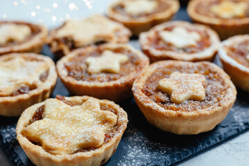 Christmas mince pies with fruit filling on a gray background.