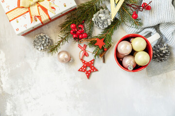 Christmas mug with red decorations and Christmas gift. Winter holiday theme concept. Merry Christmas and Happy Holidays greeting card New Year. View from above. Copy space.