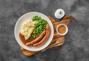Grilled Beef bratwurst with mash potato and green pea. German sausages. Rinderbratwurst. BBQ beef...