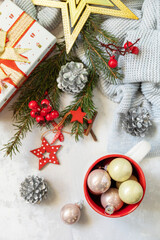 Christmas mug with red decorations and Christmas gift. Winter holiday theme concept. Merry Christmas and Happy Holidays greeting card New Year. View from above.