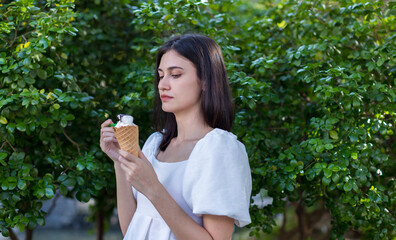 Beauty young woman eating an ice cream. Cheerful young women eating icecream.  woman eat ice cream dessert in waffle cone at outdoor