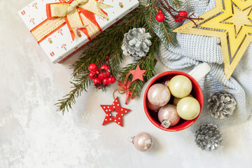 Christmas mug with red decorations and Christmas gift. Winter holiday theme concept. Merry Christmas and Happy Holidays greeting card New Year. View from above. Copy space.