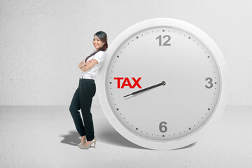Asian businesswoman leaning on the clock with a countdown for taxes
