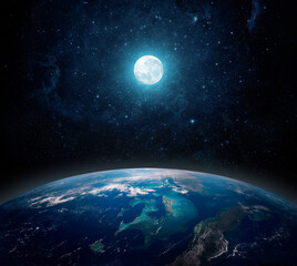 Fototapeta na wymiar A full moon above the planet Earth. View from space to the starry sky full moon and the planet Earth. Elements of this image furnished by NASA.