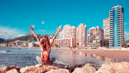 Happy traveler woman tourist enjoying beautiful city landscape and tropical beach in Calpe, ...