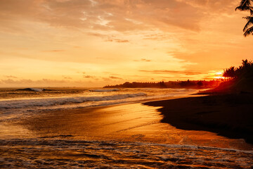 Fototapeta na wymiar Sunset with ocean waves and beach in Bali