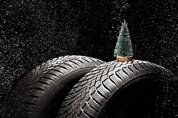 Winter Car tire for snow, forest pine tree and snowflakes isolated on black background. New...