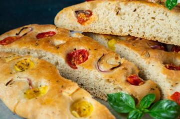 Homemade Italian Focaccia with basil and tomatoes. Italian food. Italian bread