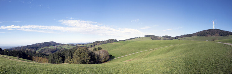 Panoramic view of landscapes around Gersbach in Black Forest. Wind turbines on top of green hills...