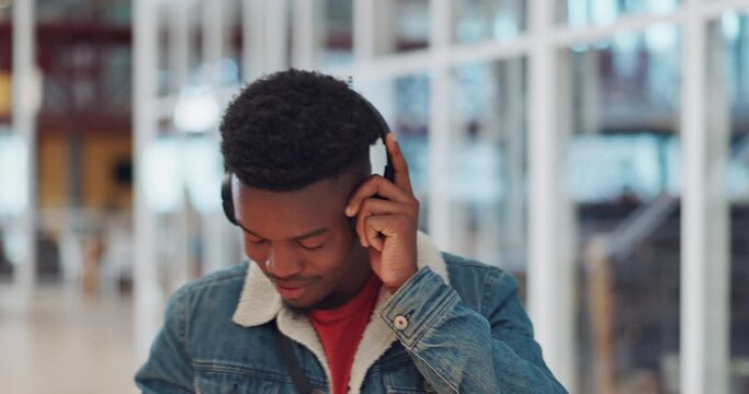 Black man, music headphones and dancing in modern university, creative school or audio college with sound innovation, vision or ideas. Student, DJ and dance person listening to freedom radio podcast