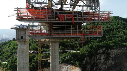 Aerial drone view on highway bridge road under construction. Construction of the viaduct on the...