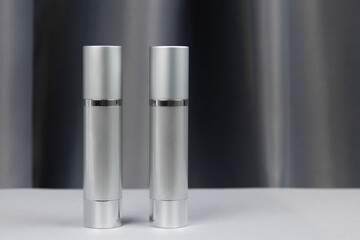 gray packaging for cosmetics on a gray background