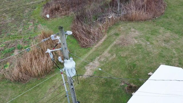 Aerial orbit of a KU electrical distribution structure with lots of equipment like polymer insulators, transformer, cotter keys, guy wire, fuses and ect. 4k